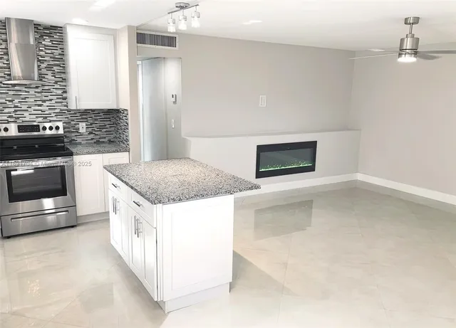 a kitchen with stainless steel appliances granite countertop a stove and a refrigerator