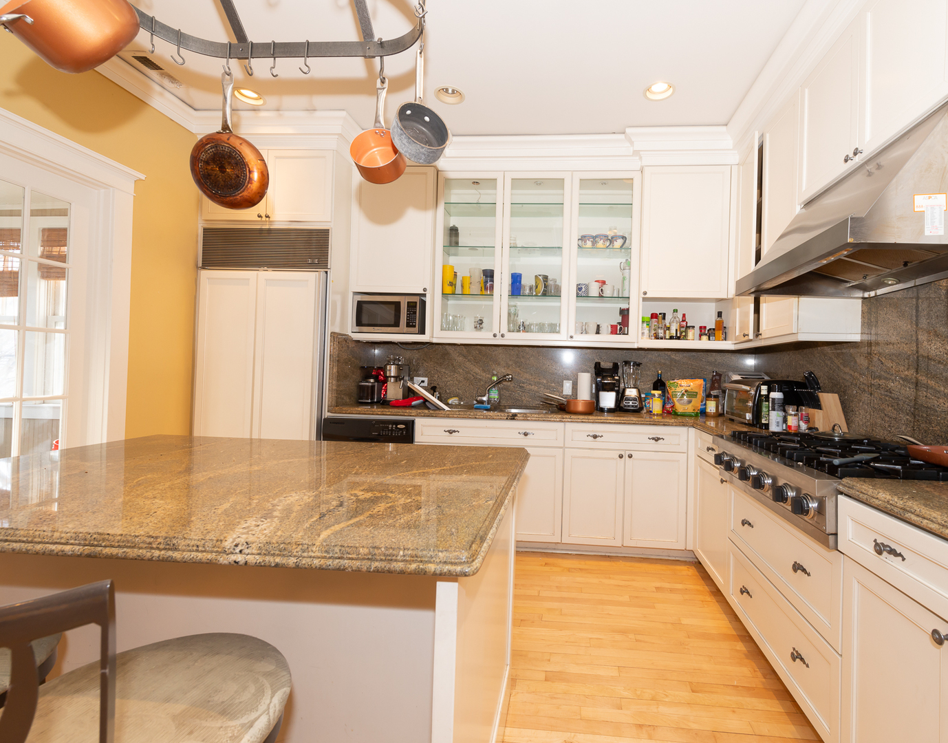 1127 West George Street Chicago, IL 60657 - Photo 2 of 16 a kitchen with stainless steel appliances granite countertop a stove and cabinets