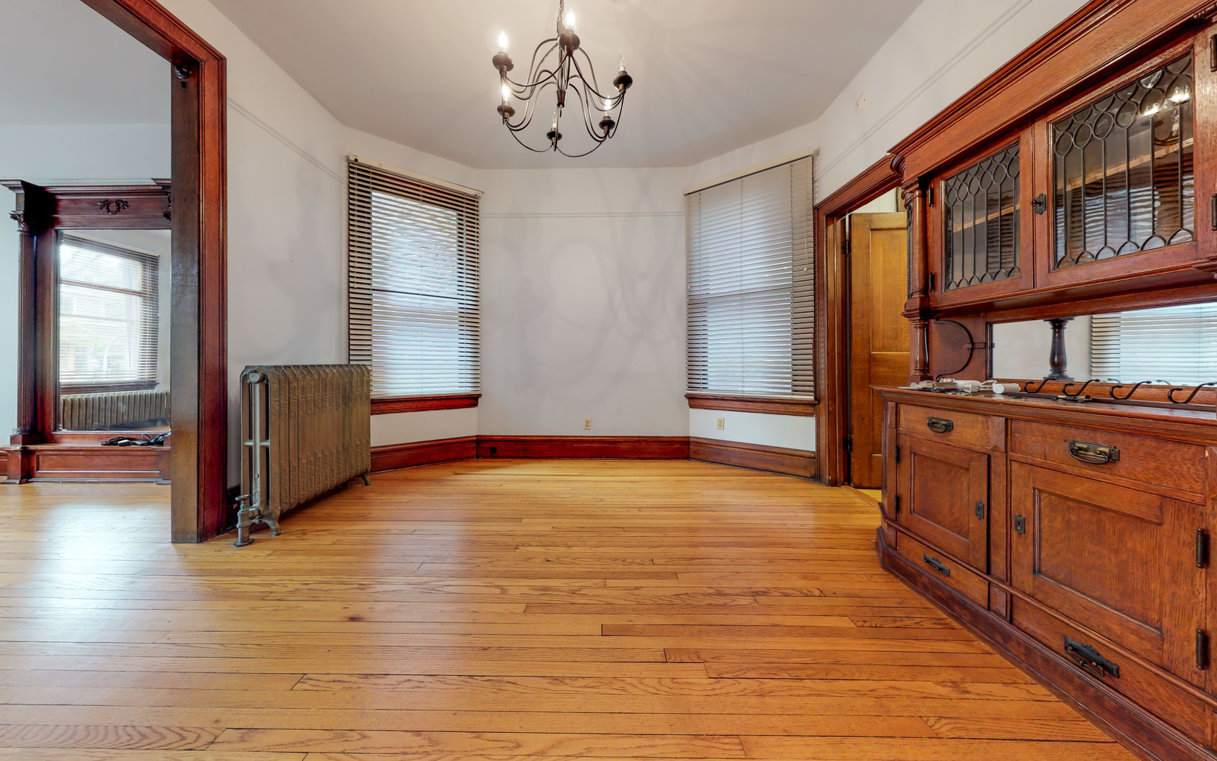 1127 West George Street Chicago, IL 60657 - Photo 11 of 16 a view of an empty room with window and wooden floor