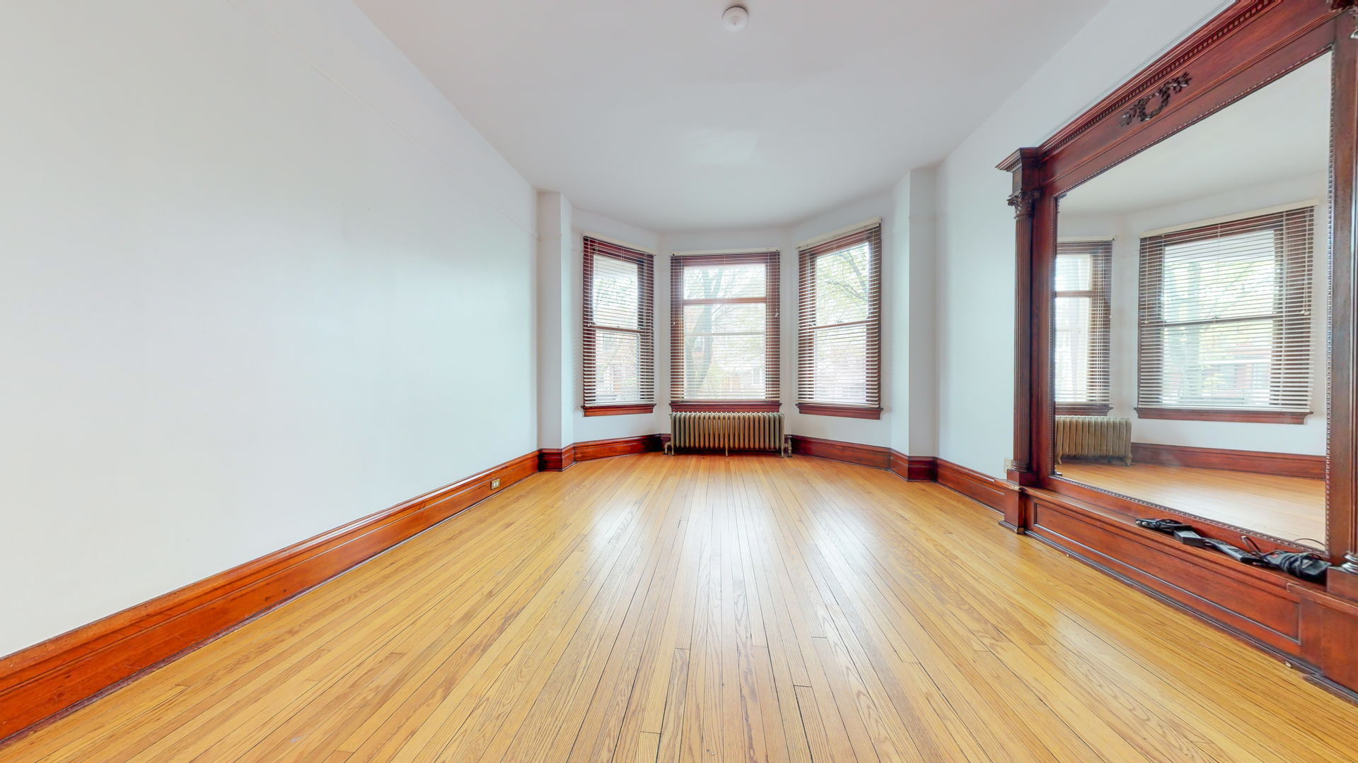 1127 West George Street Chicago, IL 60657 - Photo 13 of 16 wooden floor in an empty room with a window