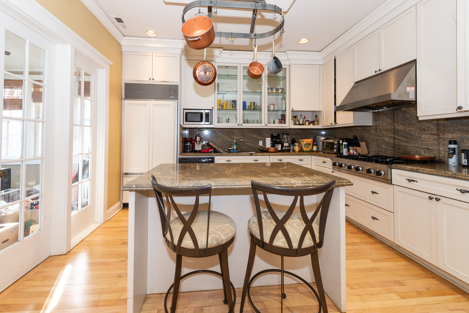 1127 West George Street Chicago, IL 60657 - Photo 3 of 16 a kitchen with stainless steel appliances granite countertop a sink and a stove