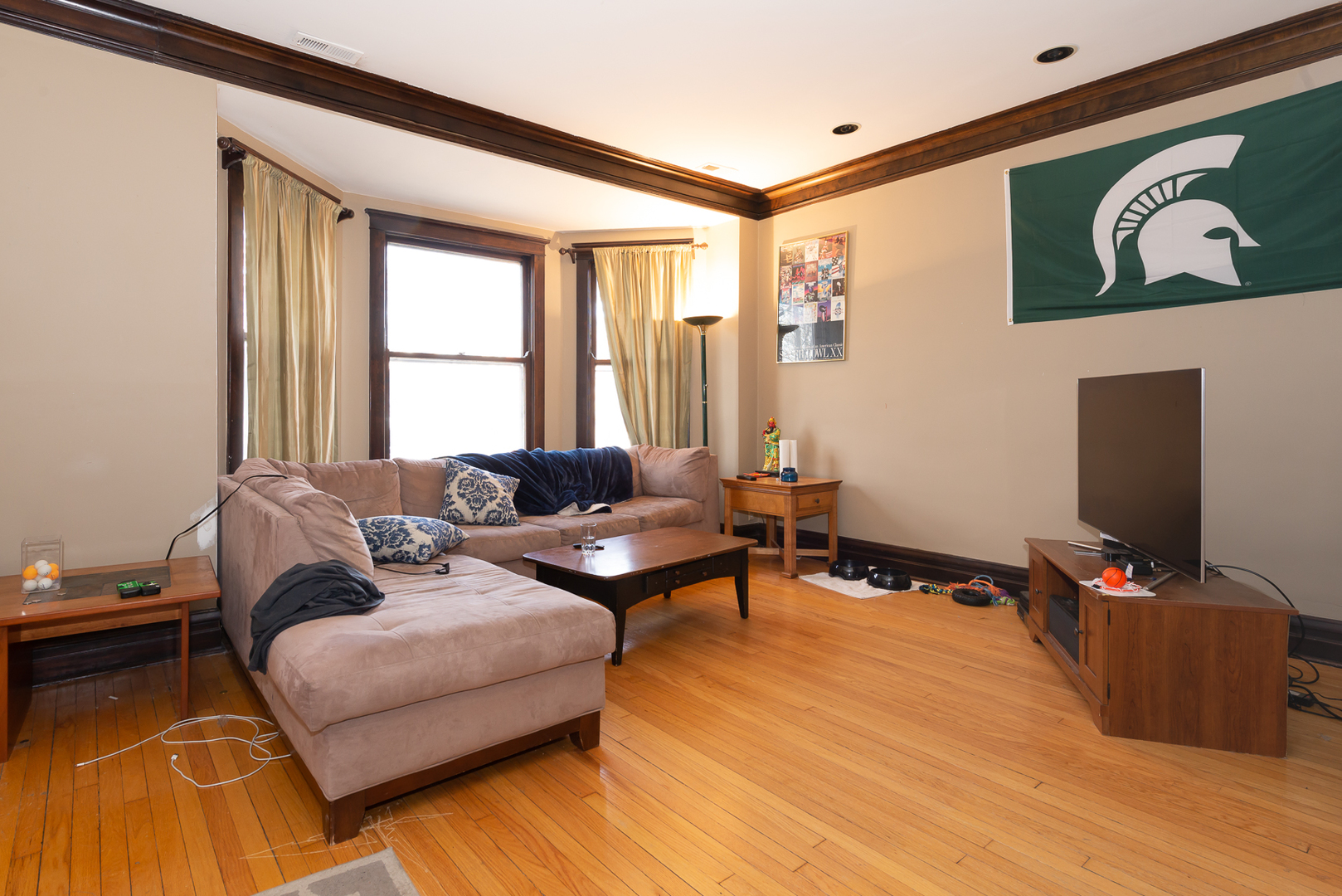 1127 West George Street Chicago, IL 60657 - Photo 4 of 16 a living room with furniture a flat screen tv and a window