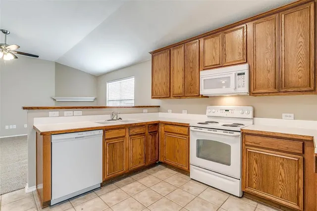 a kitchen with stainless steel appliances granite countertop a stove sink and cabinets