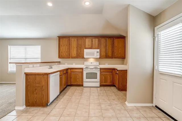 a kitchen with a stove top oven sink and cabinets