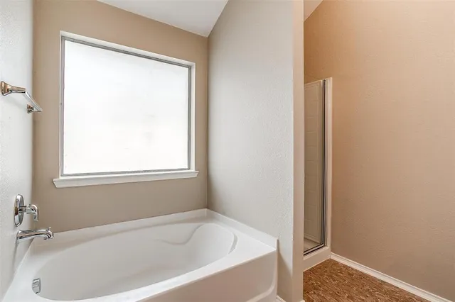 a white bath tub sitting next to a window