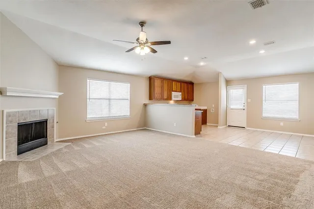 a view of livingroom with fireplace cabinet and windows