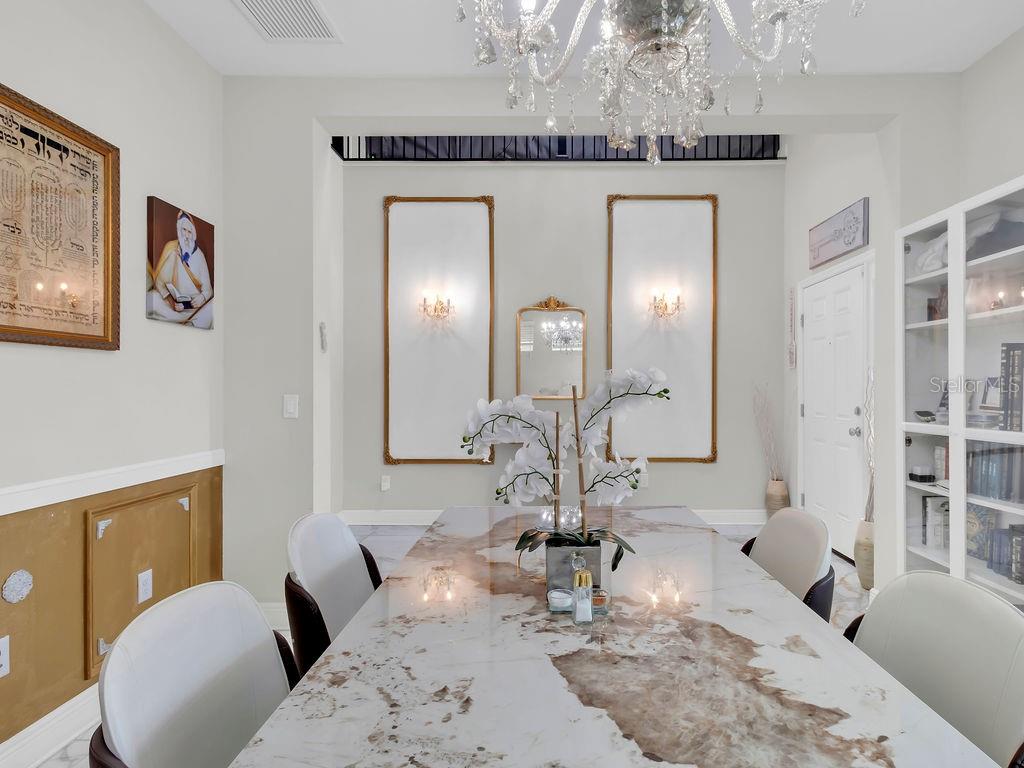 7406 Sweeter Tide Trail Wesley Chapel, FL 33545 - Photo 11 of 74 a living room with furniture and a mirror