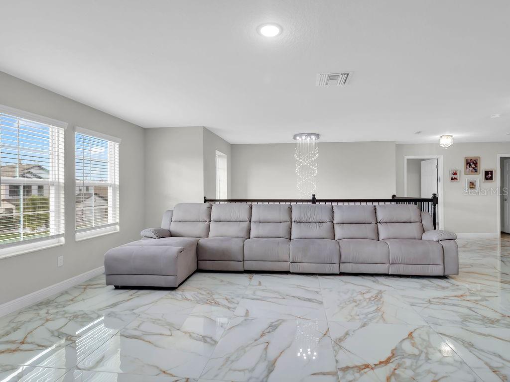 7406 Sweeter Tide Trail Wesley Chapel, FL 33545 - Photo 43 of 74 a view of a livingroom with furniture and windows