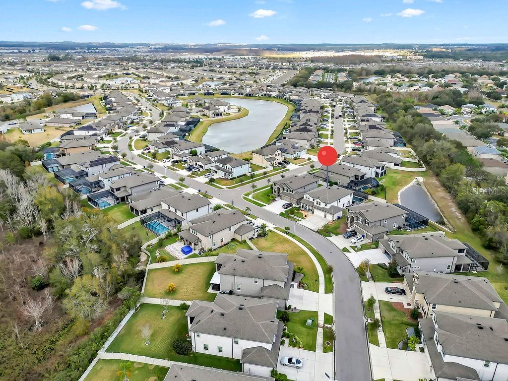 7406 Sweeter Tide Trail Wesley Chapel, FL 33545 - Photo 61 of 74 an aerial view of residential houses with outdoor space