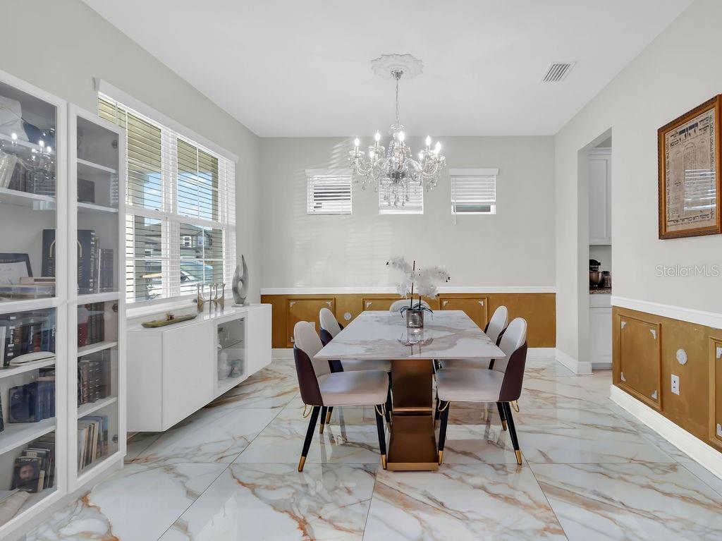 7406 Sweeter Tide Trail Wesley Chapel, FL 33545 - Photo 8 of 74 a view of a dining room with furniture and chandelier