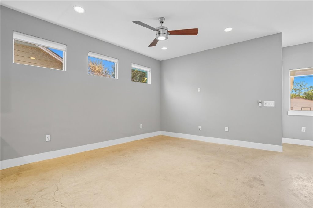 6902 Bennett Avenue, Unit B Austin, TX 78752 - Photo 11 of 27 Empty room with recessed lighting, healthy amount of natural light, ceiling fan, and unfinished concrete flooring