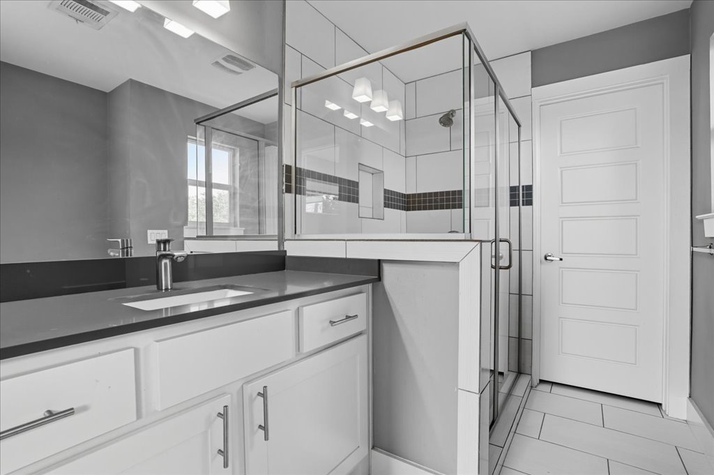 6902 Bennett Avenue, Unit B Austin, TX 78752 - Photo 14 of 27 Bathroom featuring vanity, a shower stall, and light tile patterned floors