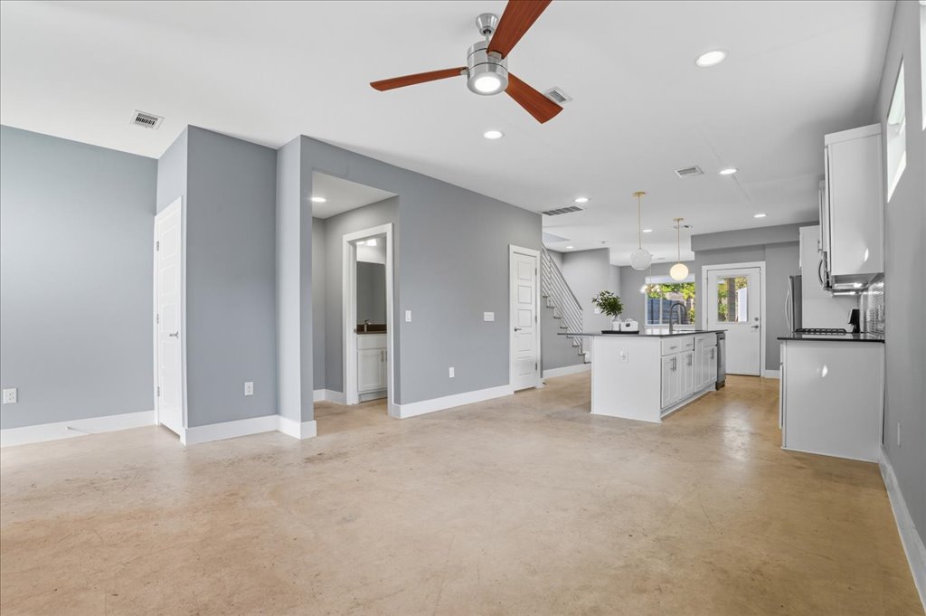 6902 Bennett Avenue, Unit B Austin, TX 78752 - Photo 6 of 27 Unfurnished living room with concrete floors, recessed lighting, ceiling fan, and stairs