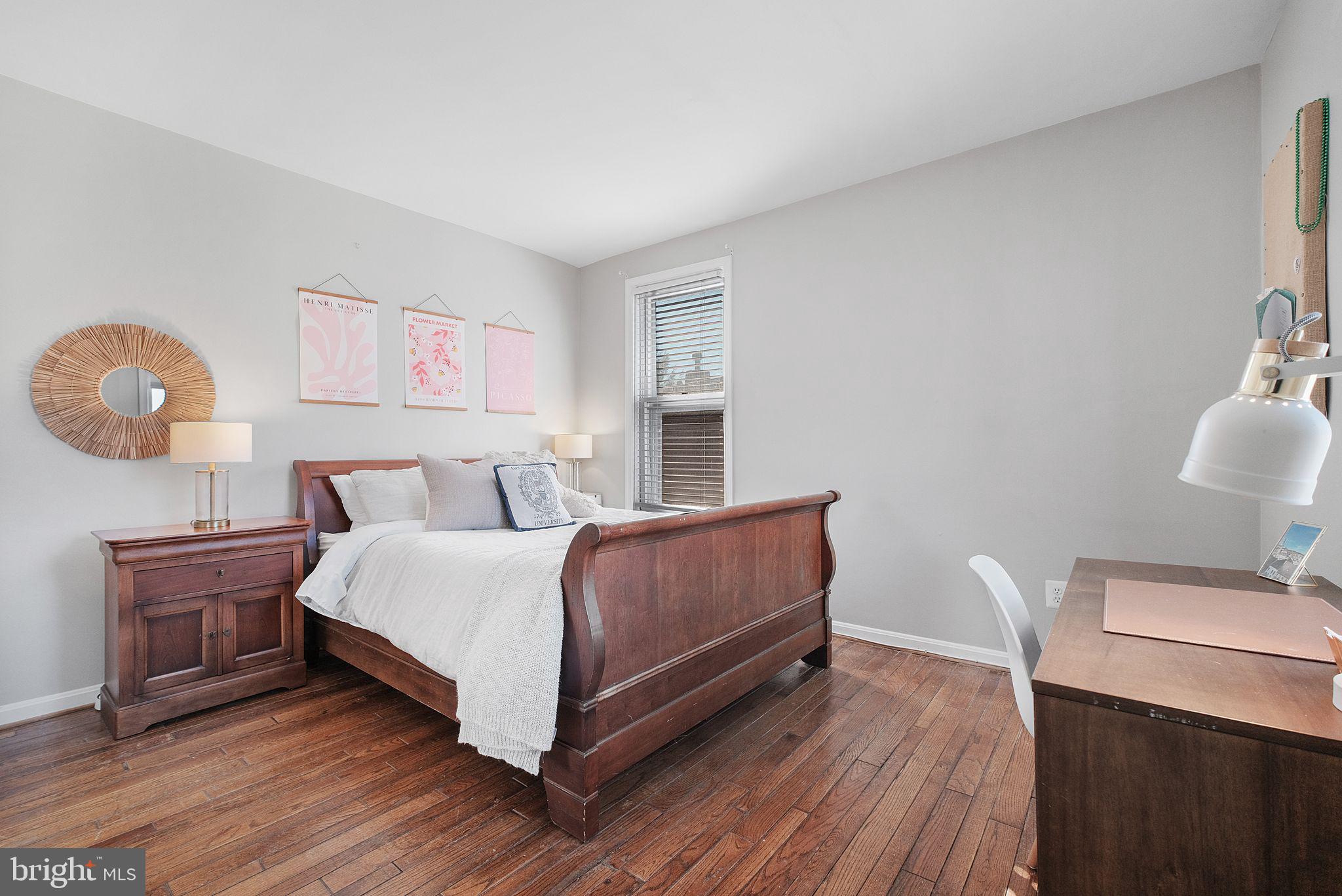 3256 Q Street Northwest Washington, DC 20007 - Photo 12 of 20 a bedroom with a bed and painting on the wall