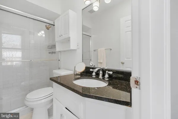 a bathroom with a sink toilet and a mirror