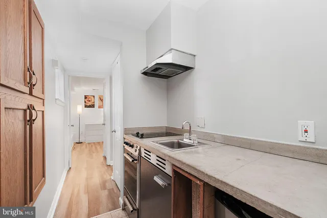 a kitchen with stainless steel appliances granite countertop a sink a stove and a refrigerator