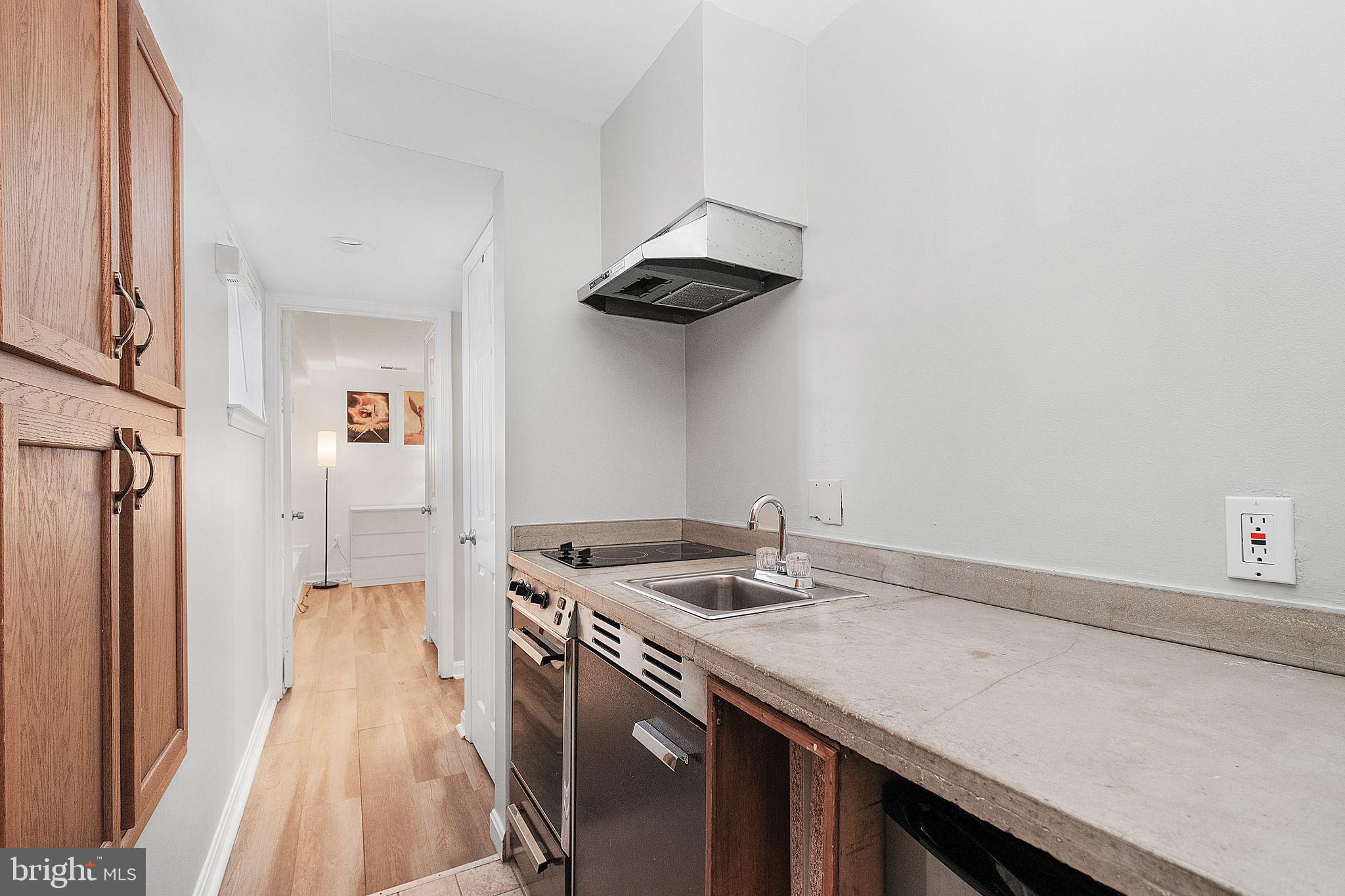 3256 Q Street Northwest Washington, DC 20007 - Photo 16 of 20 a kitchen with stainless steel appliances granite countertop a sink a stove and a refrigerator