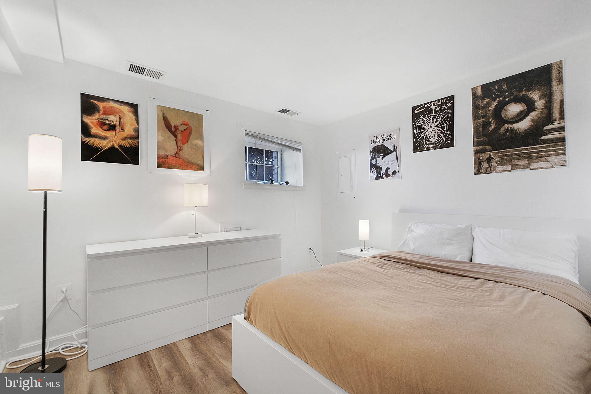 3256 Q Street Northwest Washington, DC 20007 - Photo 17 of 20 a bedroom with a bed and painting on the wall