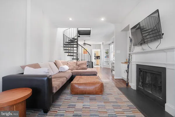 a living room with furniture a fireplace and a table