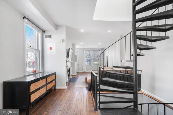 a view of entryway with wooden floor and stairs