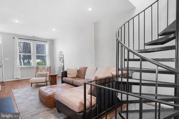 a living room with furniture and stairs