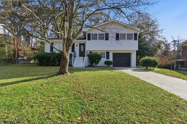 a front view of a house with a yard and garage