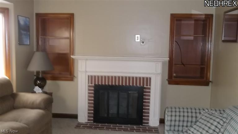 4335 7th Street Northwest Canton, OH 44708 - Photo 6 of 21 Fireplace is decorative. Built in shelves take the place of past windows. New carpet is so pretty. A wall TV once hung above fireplace and is ready for another.