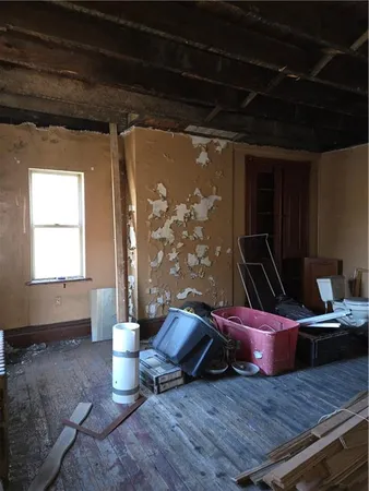 a view of a room with wooden floor and furniture