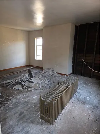 a bed sitting in a room next to a window