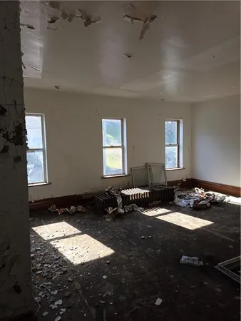 a view of a room with furniture and window