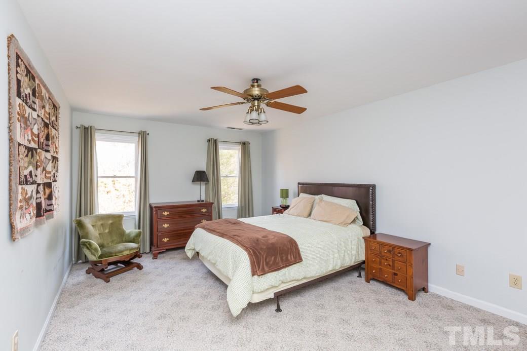 8632 Langtree Lane Raleigh, NC 27613 - Photo 12 of 25 a spacious bedroom with a bed and a window