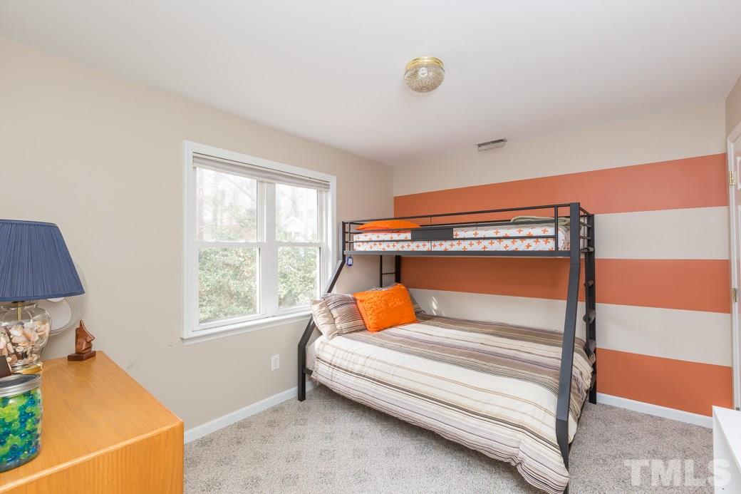 8632 Langtree Lane Raleigh, NC 27613 - Photo 13 of 25 a bedroom with a bed and window