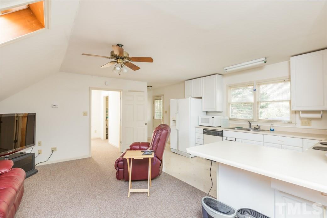 8632 Langtree Lane Raleigh, NC 27613 - Photo 17 of 25 a living room with furniture a flat screen tv and a window