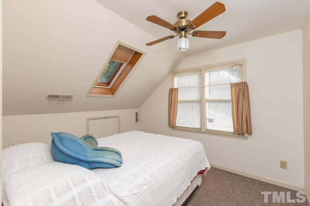 8632 Langtree Lane Raleigh, NC 27613 - Photo 18 of 25 a bedroom with a bed and a window