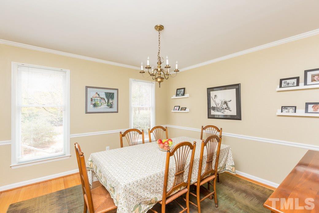 8632 Langtree Lane Raleigh, NC 27613 - Photo 3 of 25 a view of a dining room with furniture and a chandelier