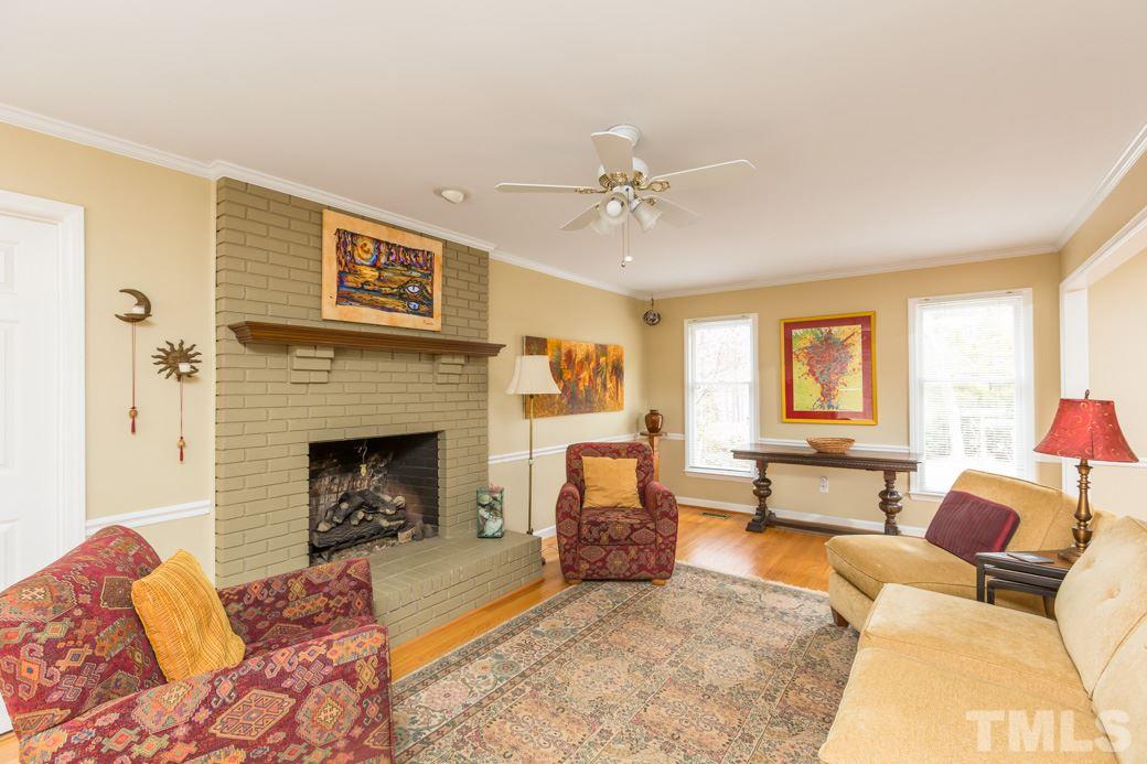 8632 Langtree Lane Raleigh, NC 27613 - Photo 4 of 25 a living room with furniture and a fireplace