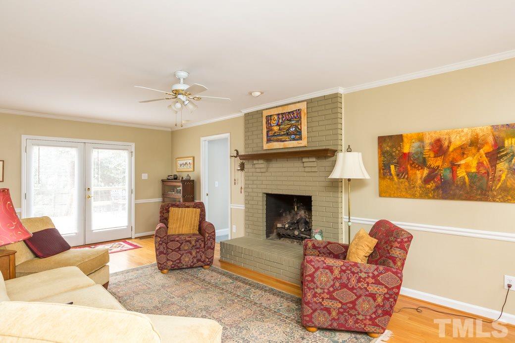 8632 Langtree Lane Raleigh, NC 27613 - Photo 5 of 25 a living room with furniture and a fireplace