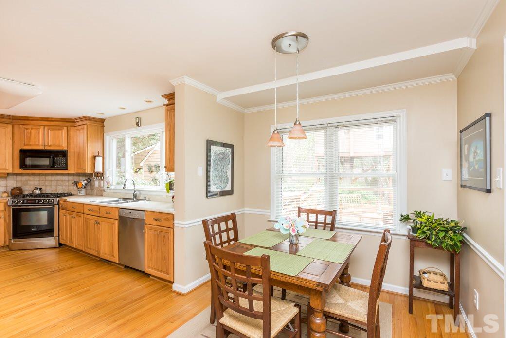 8632 Langtree Lane Raleigh, NC 27613 - Photo 8 of 25 a view of a dining room with furniture a chandelier and wooden floor