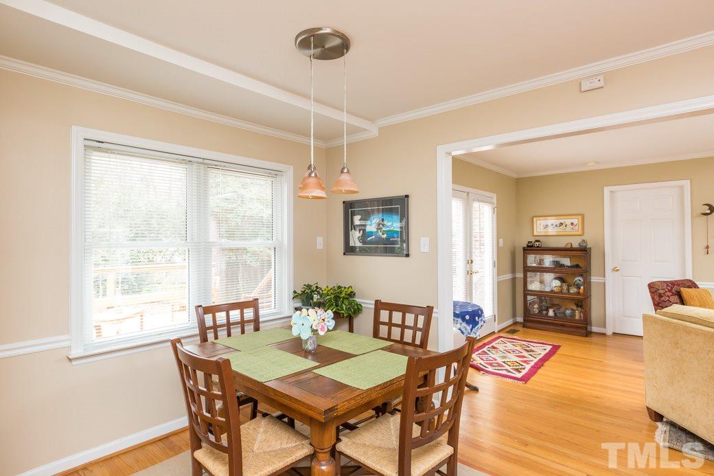 8632 Langtree Lane Raleigh, NC 27613 - Photo 9 of 25 a view of a dining room with furniture and a potted plant