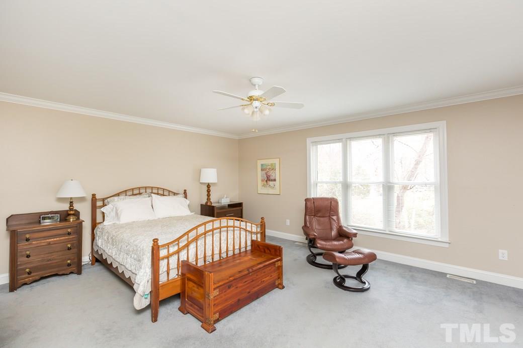 8632 Langtree Lane Raleigh, NC 27613 - Photo 10 of 25 a bedroom with a bed and a window