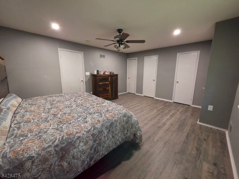 1030 Robin Road Hillsborough, NJ 08844 - Photo 5 of 22 a spacious bedroom with a bed and a chandelier