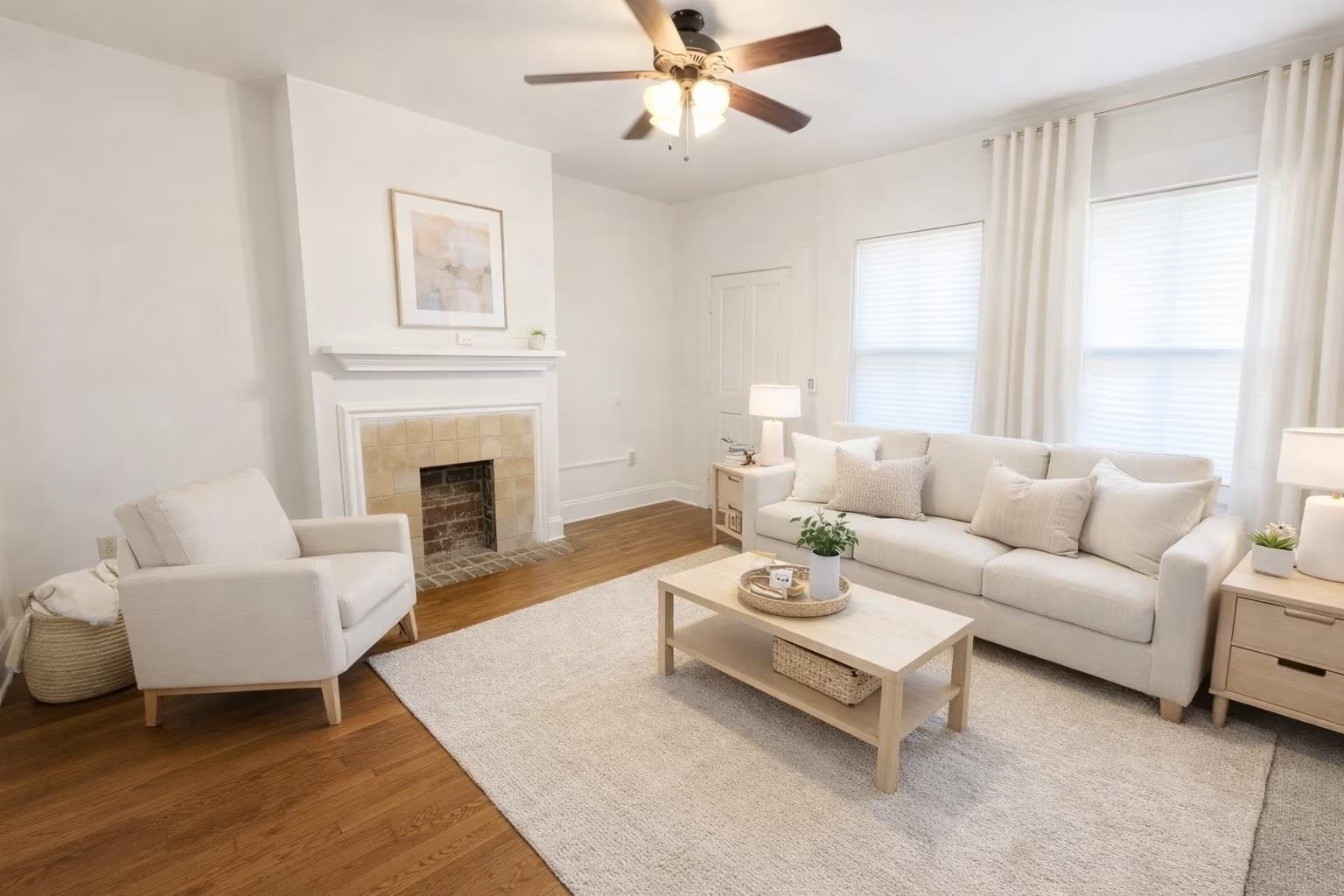 129 Talbot Avenue, Unit 103 Memphis, TN 38103 - Photo 2 of 5 Living area featuring light wood-type flooring, a ceiling fan, and a tiled fireplace