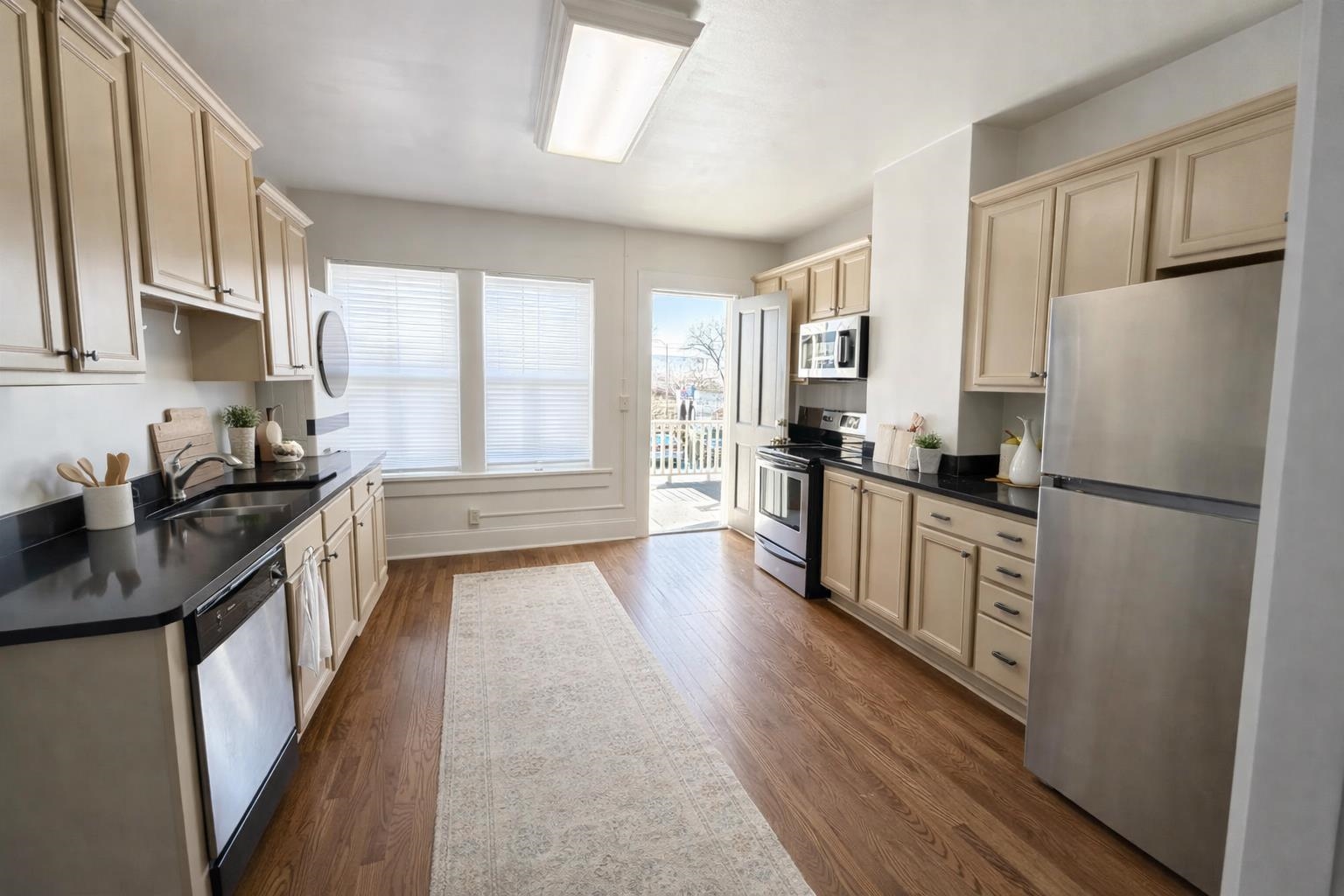 129 Talbot Avenue, Unit 103 Memphis, TN 38103 - Photo 3 of 5 Kitchen with stainless steel appliances and dark wood-type flooring