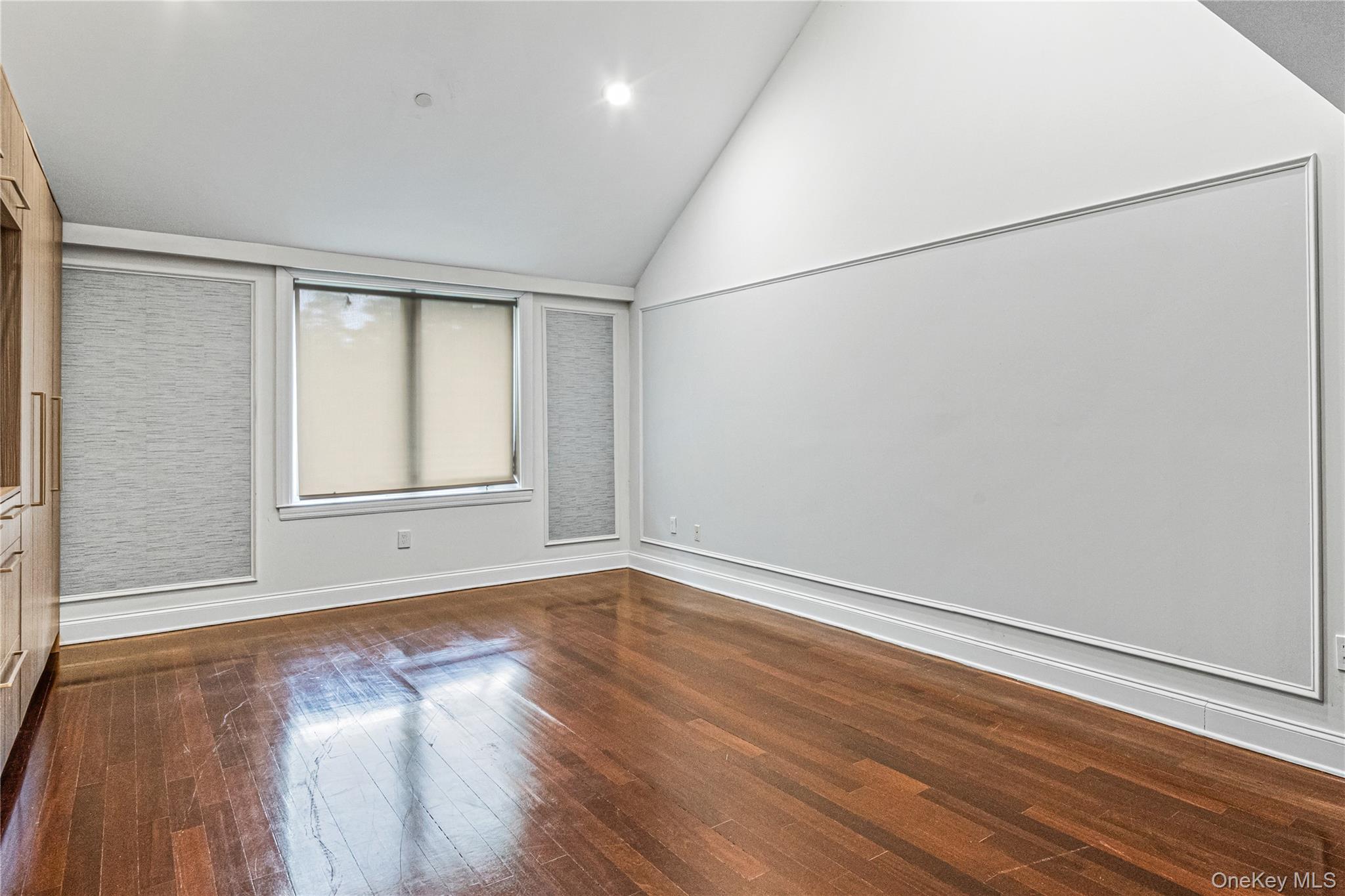 171 Great Neck Road, Unit 4R Great Neck, NY 11021 - Photo 10 of 27 an empty room with wooden floor and windows