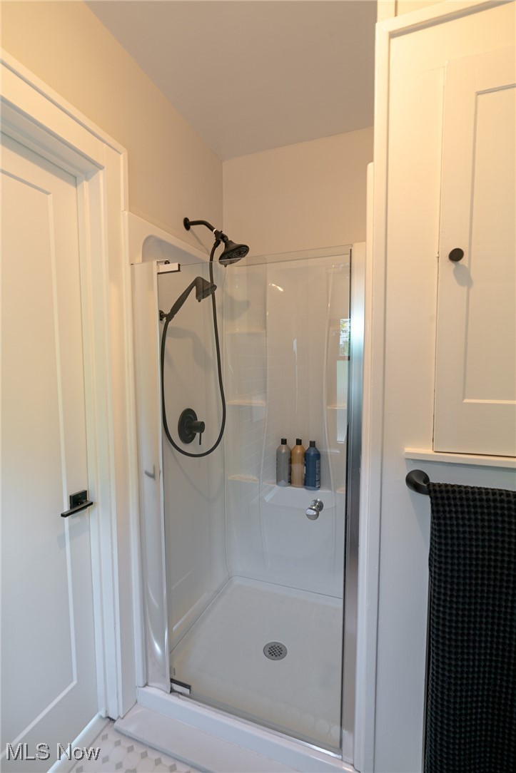 2624 Lee Road Cleveland, OH 44118 - Photo 26 of 50 Bathroom with a shower featuring glass door, ceramic floor and linen closet