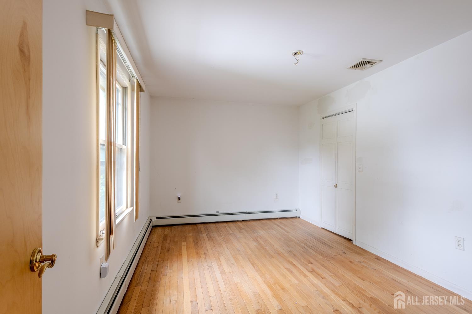 170 Jordan Road Colonia, NJ 07067 - Photo 15 of 36 an empty room with wooden floor and windows