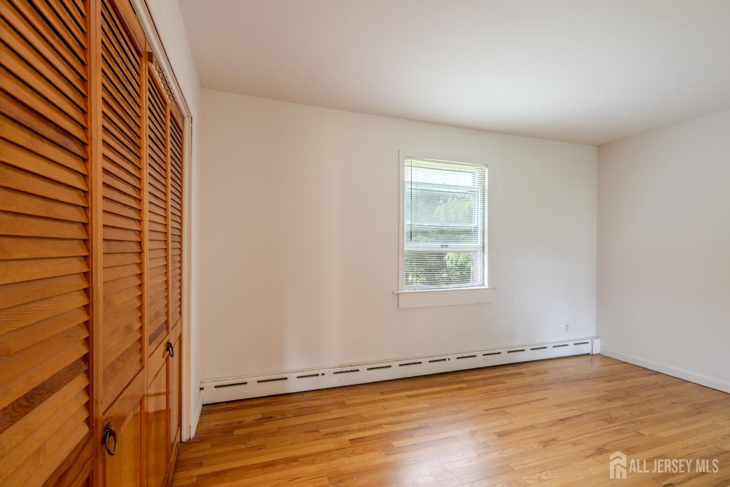 170 Jordan Road Colonia, NJ 07067 - Photo 19 of 36 an empty room with wooden floor and windows