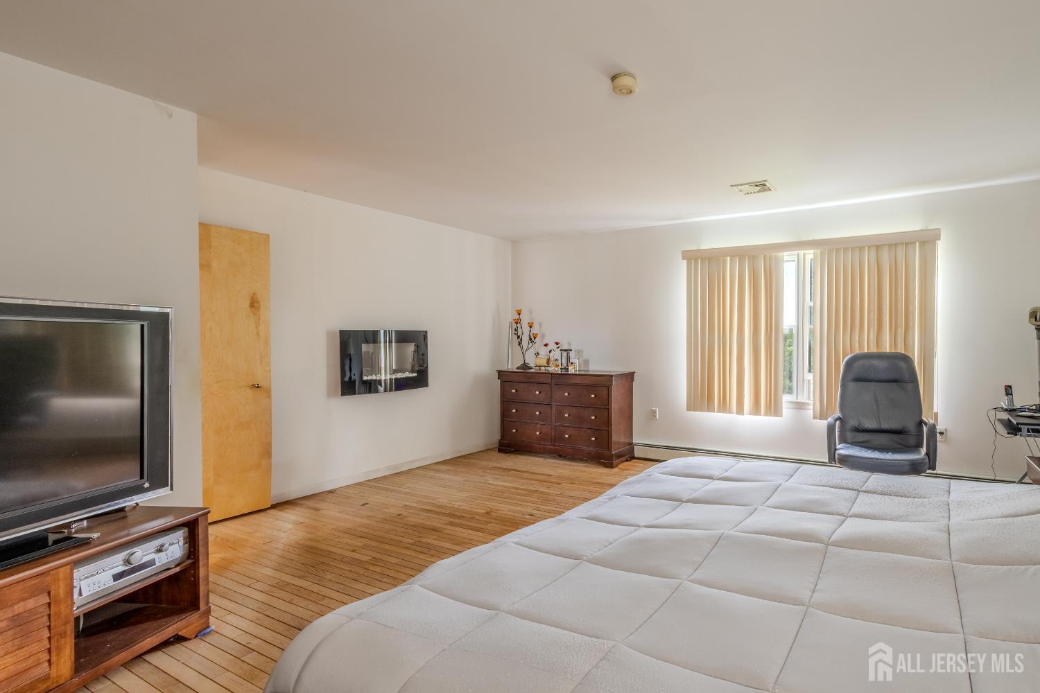 170 Jordan Road Colonia, NJ 07067 - Photo 25 of 36 a bedroom with a bed and a flat screen tv