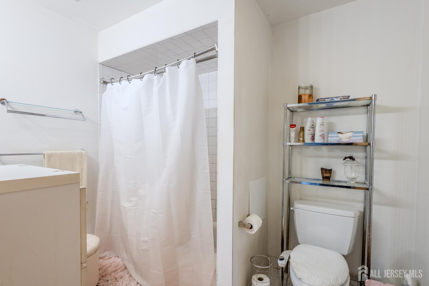 170 Jordan Road Colonia, NJ 07067 - Photo 29 of 36 a bathroom with a toilet and a shower curtain