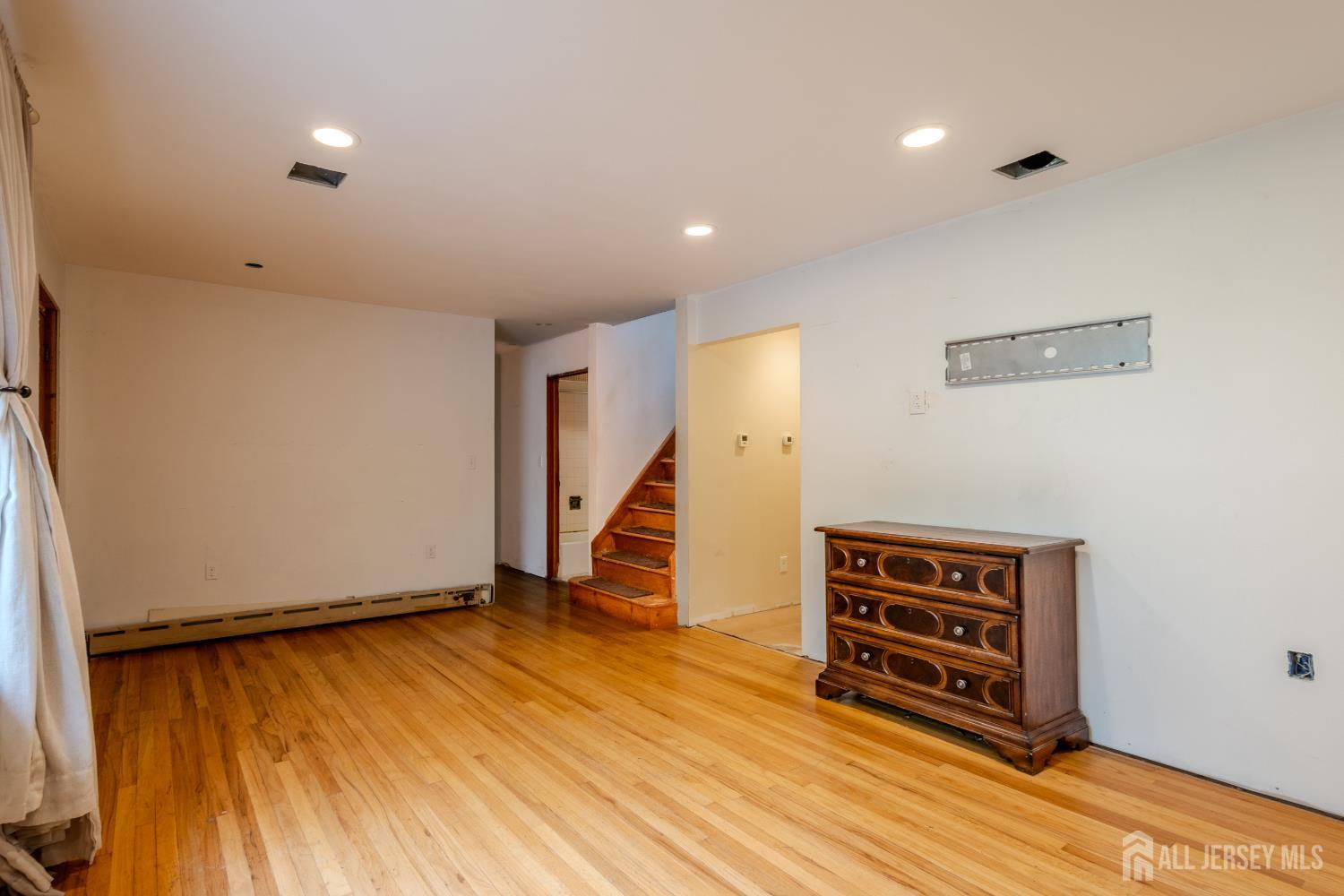 170 Jordan Road Colonia, NJ 07067 - Photo 5 of 36 a view of room with stairs and wooden floor